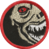Haunted attraction skull badge with red eye and menacing grin for team-building events.