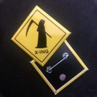 Caution sign featuring Grim Reaper silhouette for haunted attraction decor.
