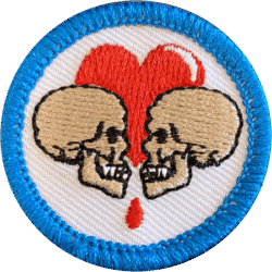 A haunting embroidered badge featuring two skulls facing each other with a red heart in the backgrou.