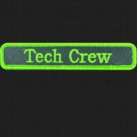 Green name badge for the tech team.