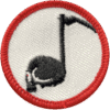 Black cat with tail wrapped around a musical note embroidered badge, haunted attraction theme.