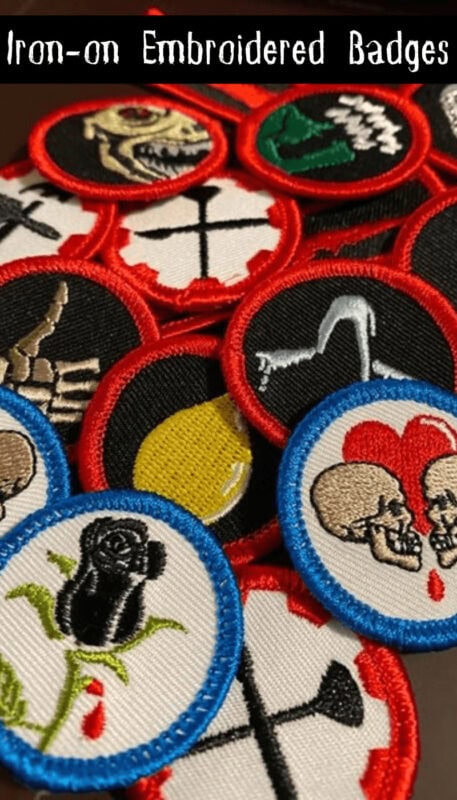 Iron-on embroidered haunted attraction badges with skull, ghost, and spooky designs for team-buildin.