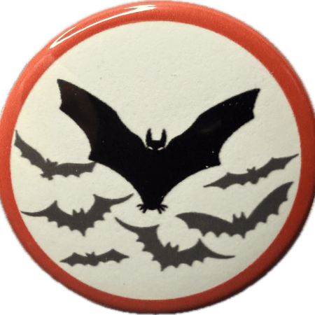 Haunted bat and bat wing silhouettes on a white badge with red border.